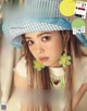 A magazine with a girl wearing a blue and white hat.