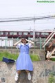 A woman in a blue dress is posing for a picture.