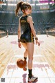 A woman holding a basketball on a basketball court.